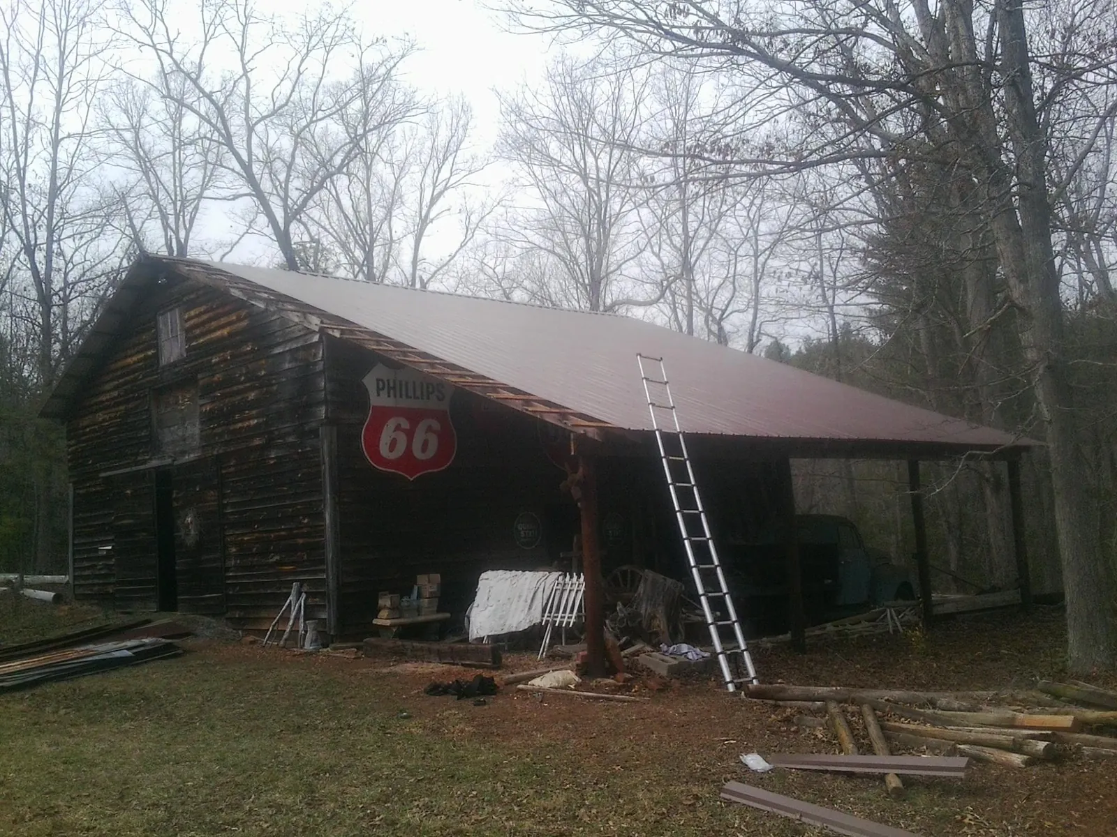 New metal roof on an open sided timber barn with a vintage sign in Verdugo City