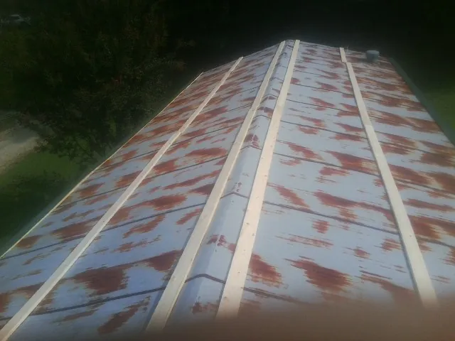 Rusted metal roof panels with new wood purlins before replacement — Storm Damage Roof Repair in Verdugo City by Roofing Brothers