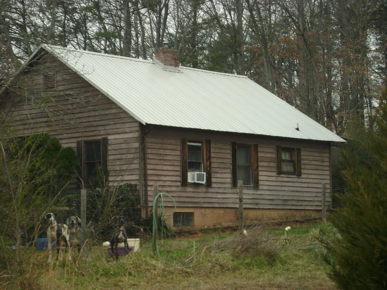 White metal roof on an old wood sided farmhouse, from a Metal Roof Installation job in Verdugo City
